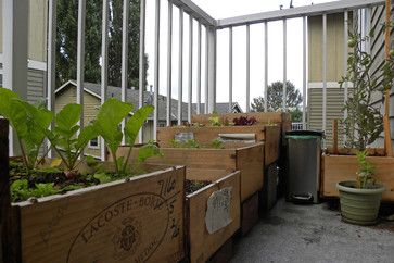 Upcycled wine boxes create an edible garden on the tiny balcony.